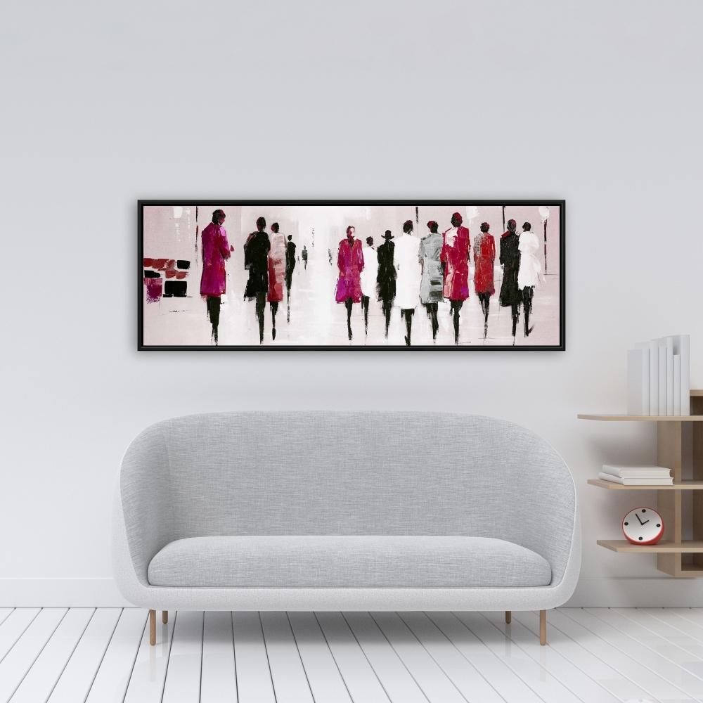 silhouettes of women walking on street in pink, black, gray, white, and red long jackets art print with black frame on wall in living room scene